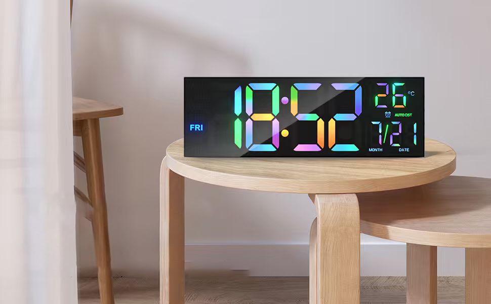 PH-01 digital wall clock with multicolour time display on a round wooden table
